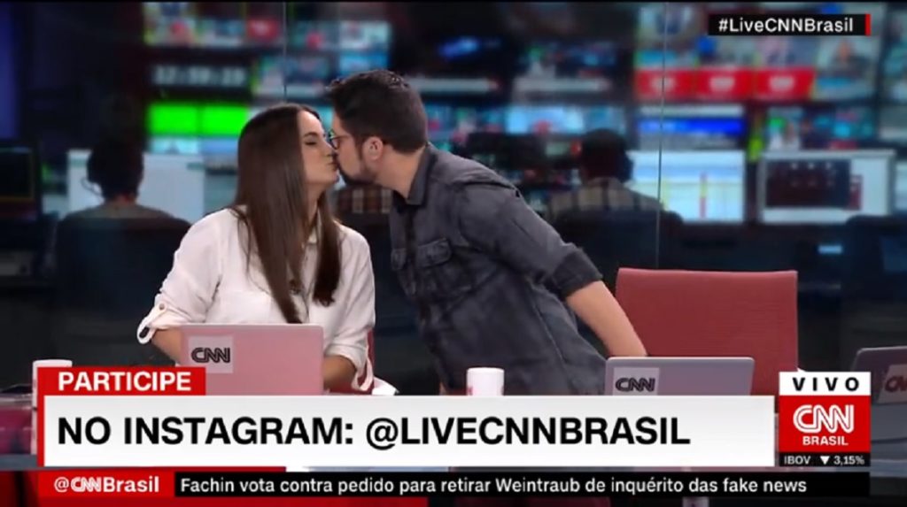 Mari Palma e Phelipe Siani se beijam, no Live CNN Brasil